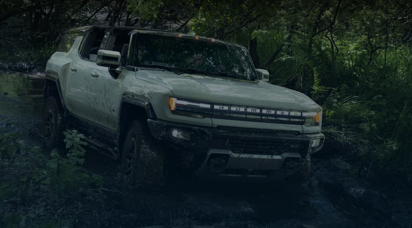Hummer EV SUV off-roading in stream